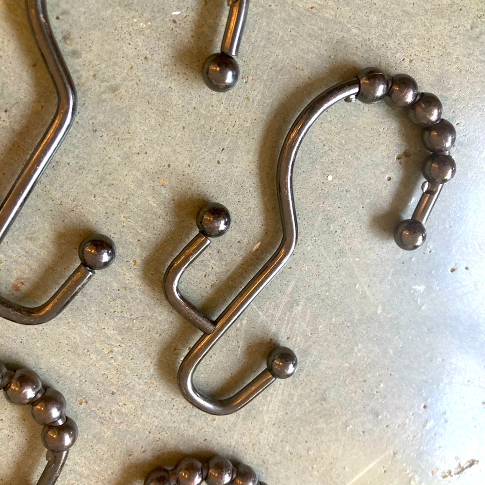 12 industrial style pewter shower curtain hooks. Perfect never used.